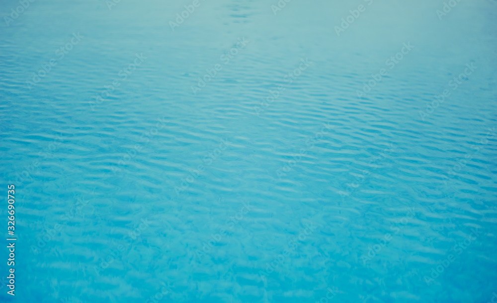 Background texture of blue water in the outdoor pool in a tropical resort