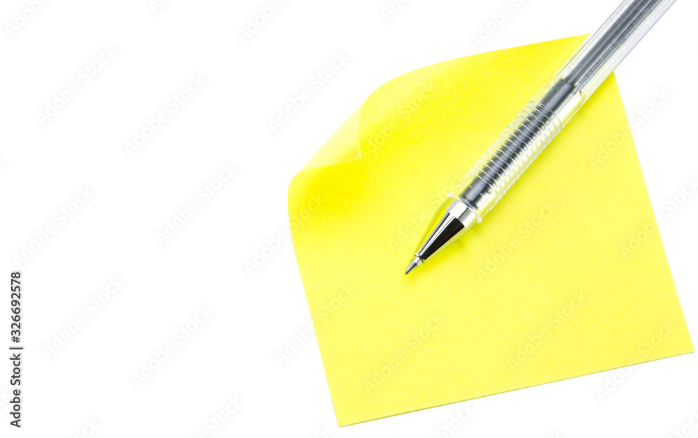 Yellow square sticker with curled up corner and transparent ballpoint pen on a white isolated background. Yellow-green sticky note paper. Yellow square sticker with curled up corner and transparent ballpoint pen on a white isolated background. Yellow-green sticky note paper.