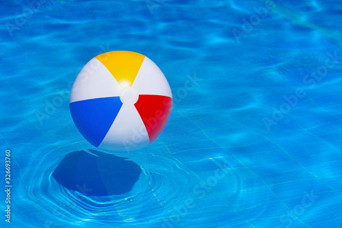 Colorful inflatable ball floating in swimming pool