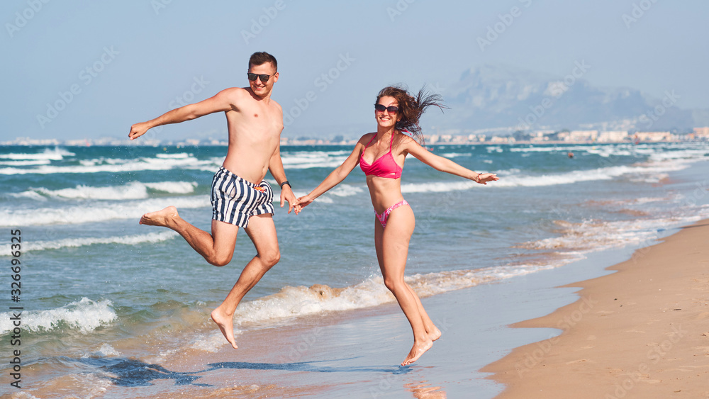 Young couple in love walking on the beach. Young couple in love walking on the beach.