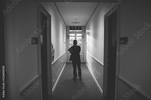 man in hotel corridor 