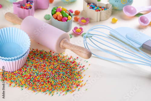 Baking and cooking concept. Cookie cutters, whisk, roller pin and kitchen bake tools for making sweets. Top view of a holiday baking still life. Sweet recipe cookbook.