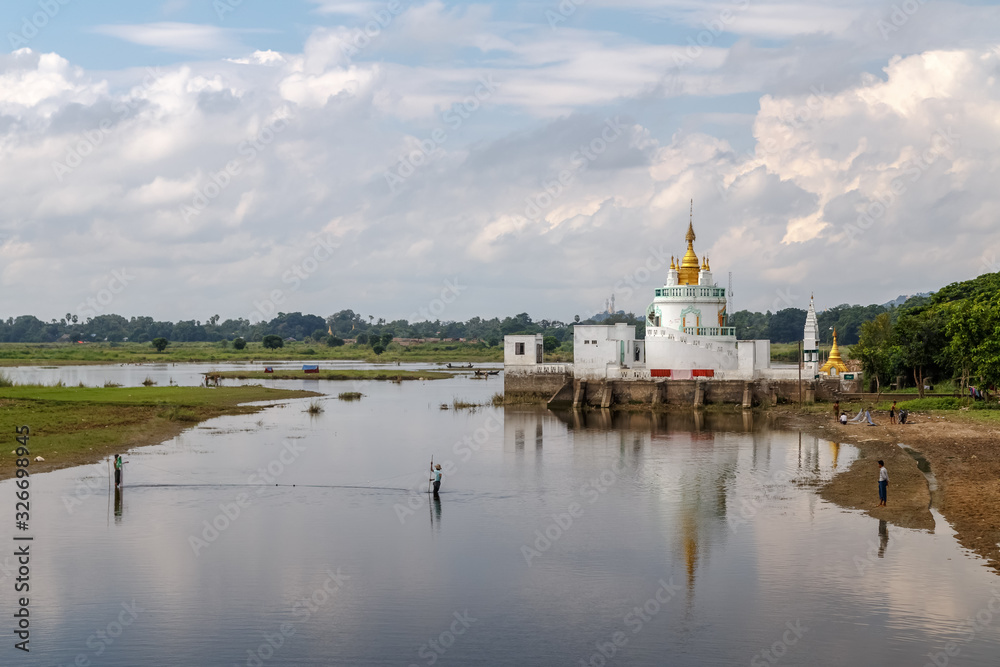 View to the Monastery on Taungthaman Lakereflected in the water from U-bein bridge near Amarapura in Myanmar (Burma). Travel Asia. View to the Monastery on Taungthaman Lakereflected in the water from U-bein bridge near Amarapura in Myanmar (Burma). Travel Asia.