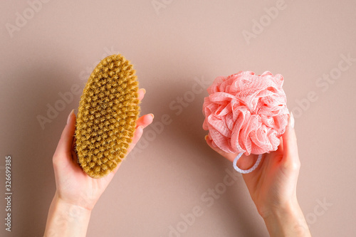 Bath shower sponge loofah vs eco-friendly natural bath massage brush comparison concept. Flat lay, top view.
