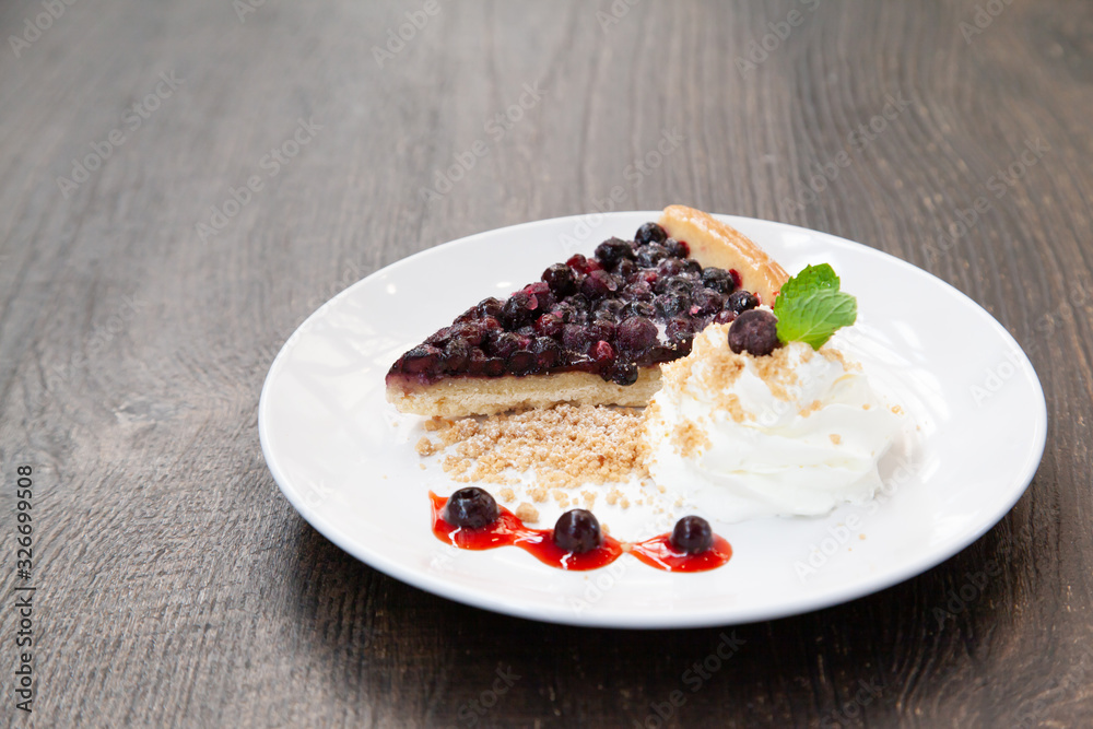 Sliced blueberry pie with fresh whipped cream and cookie crumble Sliced blueberry pie with fresh whipped cream and cookie crumble