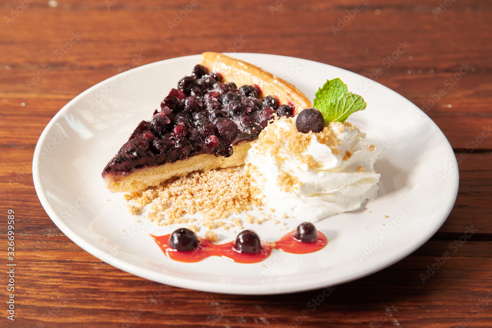 Sliced blueberry pie with fresh whipped cream and cookie crumble Sliced blueberry pie with fresh whipped cream and cookie crumble
