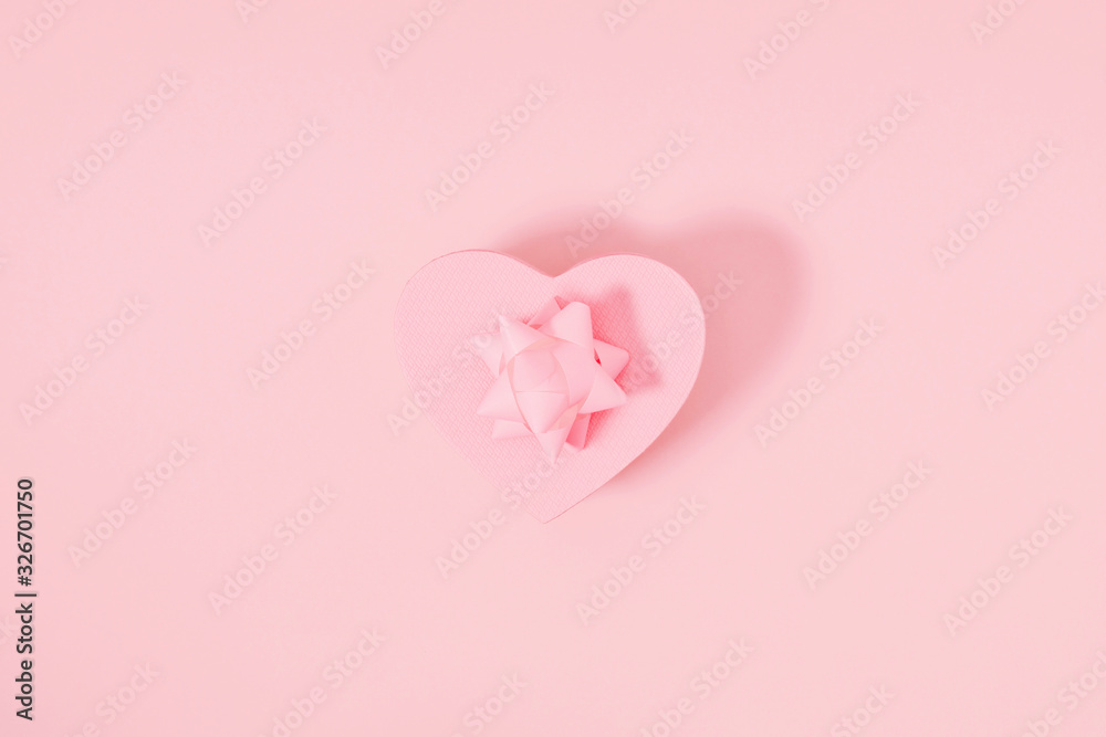 Minimal pink holiday composition. Pink background with gift. Valentines Day, Happy Women's Day, Mother's day. Flat lay, top view, copy space