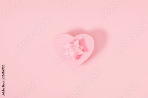 Minimal pink holiday composition. Pink background with gift. Valentines Day, Happy Women's Day, Mother's day. Flat lay, top view, copy space