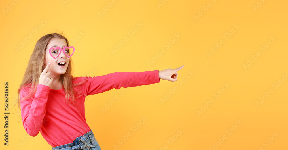 Caucasian child girl pointing,showing empty space yellow background. Caucasian child girl pointing,showing empty space yellow background.