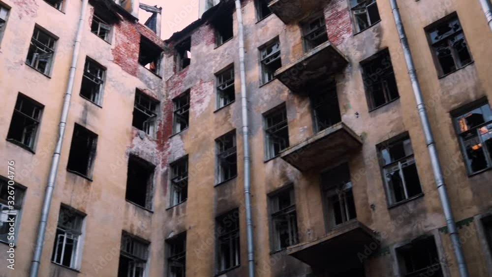 facade of an abandoned and burned building, a fire after the bombing. An old ruined building with broken Windows facade of an abandoned and burned building, a fire after the bombing. An old ruined building with broken Windows