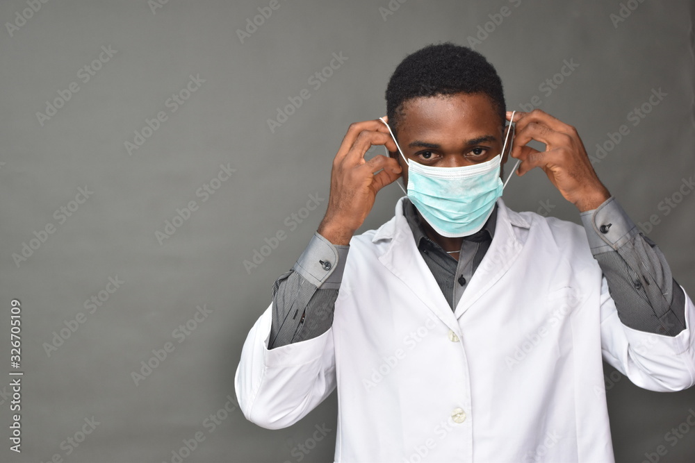 young black man wearing a white coat and face mask young black man wearing a white coat and face mask