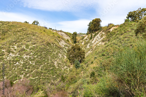 Hills overgrown with greenery near the HaTanur waterfall, which is located in the continuation of the rapid, shallow, cold mountain Ayun river in the Galilee in northern Israel