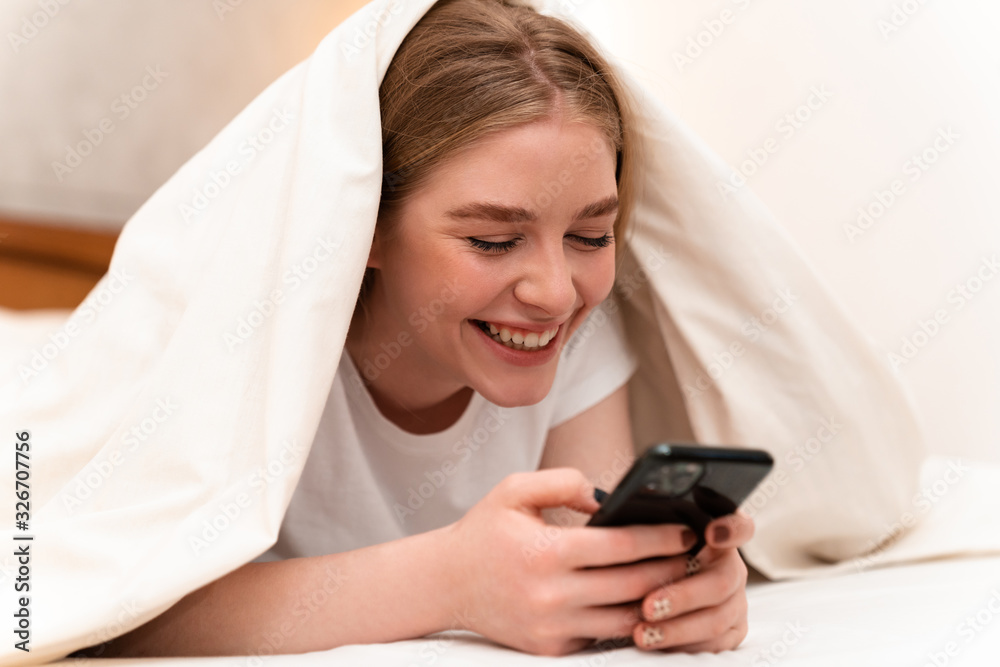 Positive pretty young woman using mobile phone. Positive pretty young woman using mobile phone.