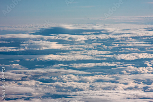 A carpet of clouds seen from the window of an airliner.