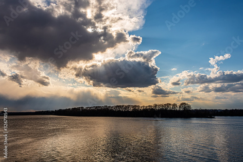 Landscape with sunbeams illuminating the river
