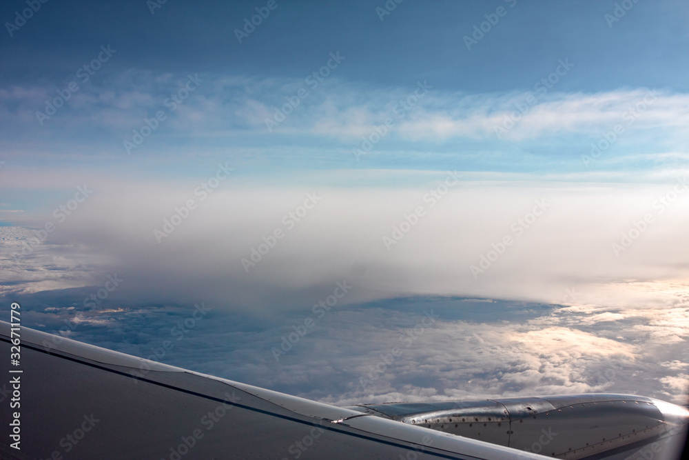 A carpet of clouds seen from the window of an airliner.