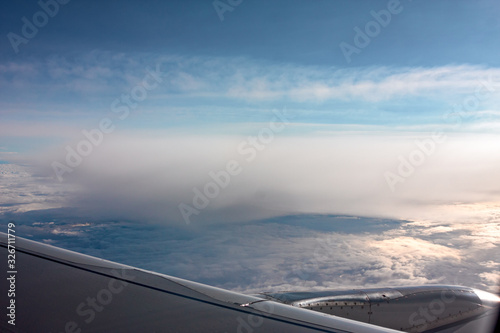 Obraz na płótnie A carpet of clouds seen from the window of an airliner. w salonie