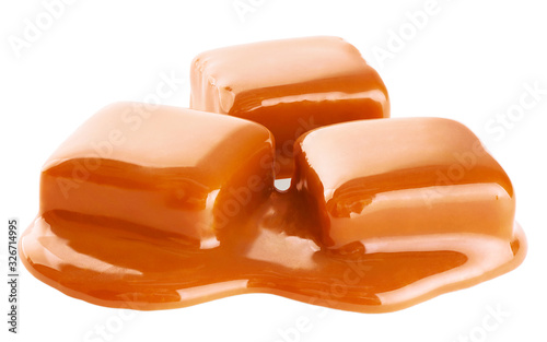 Caramel candies and sauce isolated on a white background.