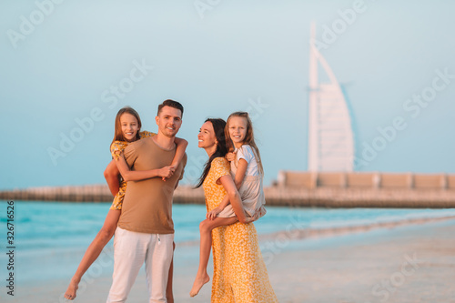 Canvastavla Happy family on the beach during summer vacation
