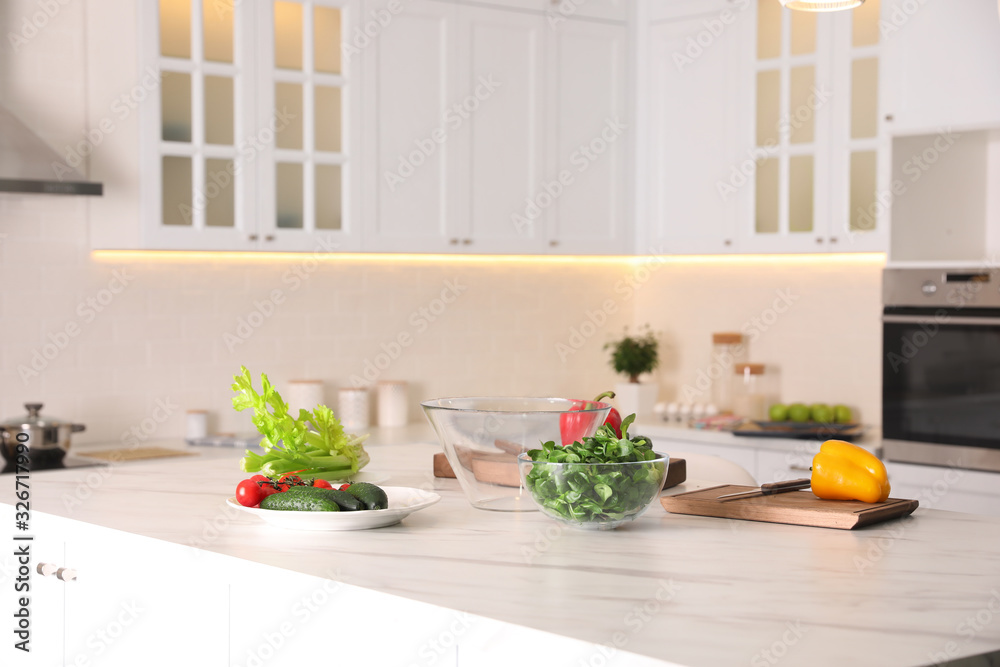 Fresh vegetables for salad on modern kitchen island Fresh vegetables for salad on modern kitchen island
