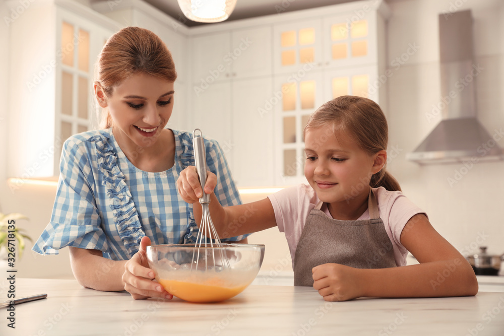 Mother and daughter making dough together in kitchen Mother and daughter making dough together in kitchen