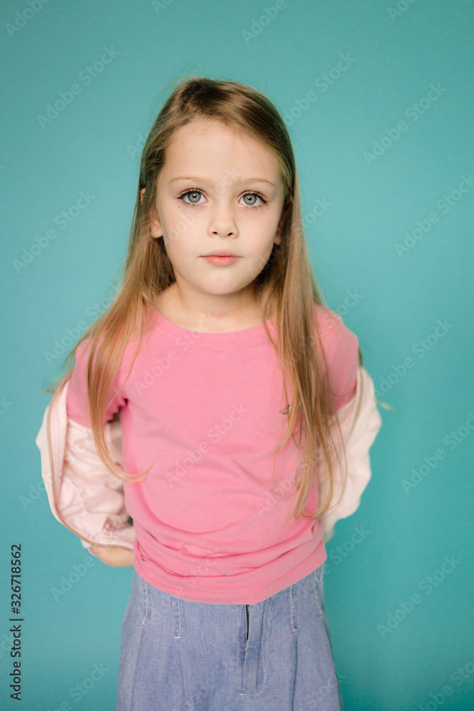 Studio model test of young girl. Lifestyle Studio portrait of young beautiful fashion girl. Emotional studio portrait of cute little girl. Portrait of smiling child Studio model test of young girl. Lifestyle Studio portrait of young beautiful fashion girl. Emotional studio portrait of cute little girl. Portrait of smiling child