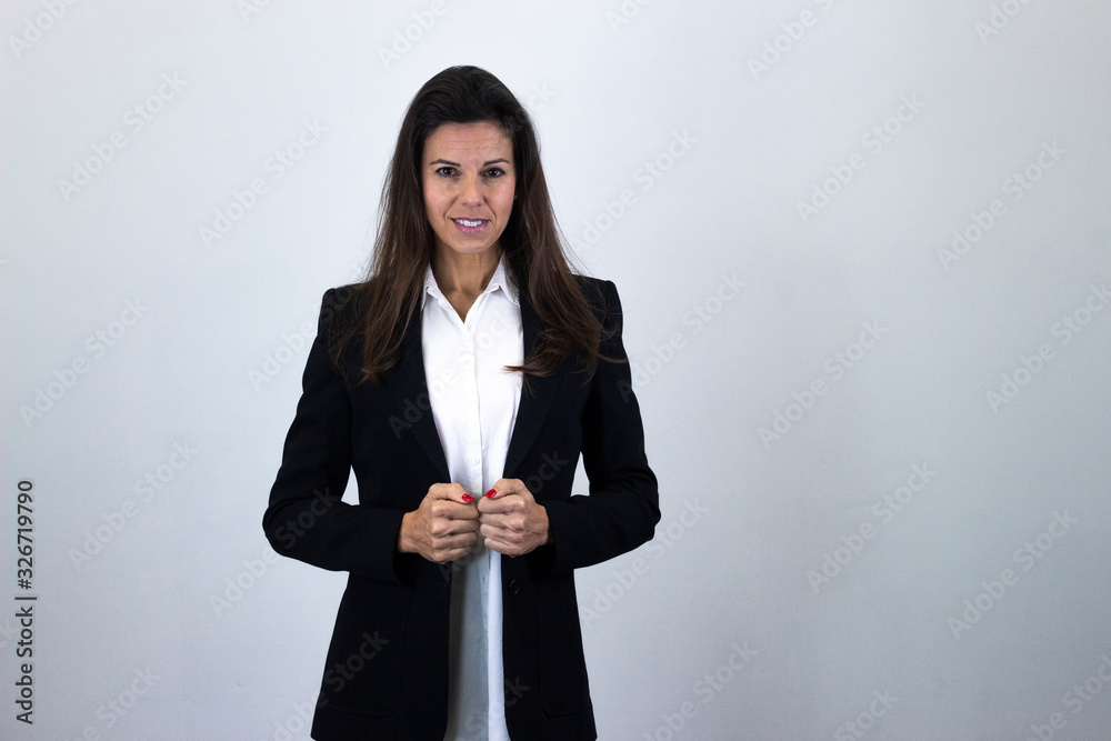 Portrait of happy attractive caucasian bussiness woman smiling, isolated on gray background studio shot, white shirt and black jacket, dark air. Place for your text in copy space. Portrait of happy attractive caucasian bussiness woman smiling, isolated on gray background studio shot, white shirt and black jacket, dark air. Place for your text in copy space.