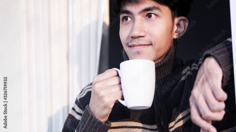 Closeup of male holding a coffee cup in the cafe add the filter retro color tone. How to lifestyle of adult businessman in the weekend activity relaxing with the coffee drinking concept.        
