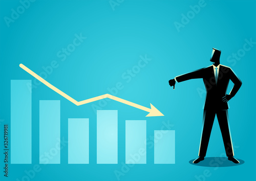 Businessman posing with thumb down with decreasing graphic chart