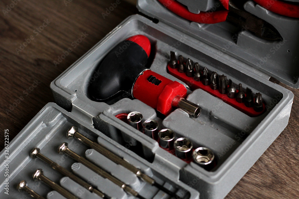 red tools in the toolbox on wooden background red tools in the toolbox on wooden background