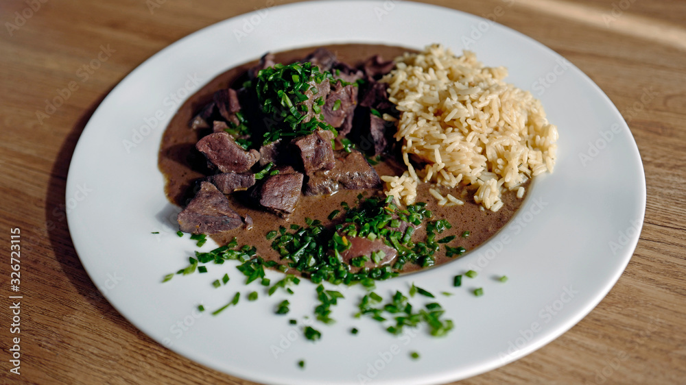 roasted liver, heart and kidneys from a red deer with sauce and rice roasted liver, heart and kidneys from a red deer with sauce and rice