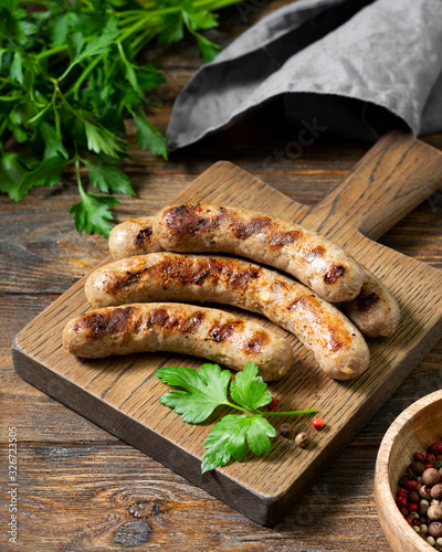 Bratwurst. Grilled sausages on a wooden Board on a light gray kitchen table. View top 