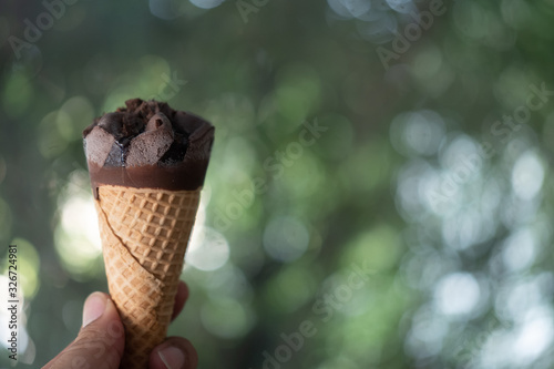 Ice cream chocolate wafer in hand