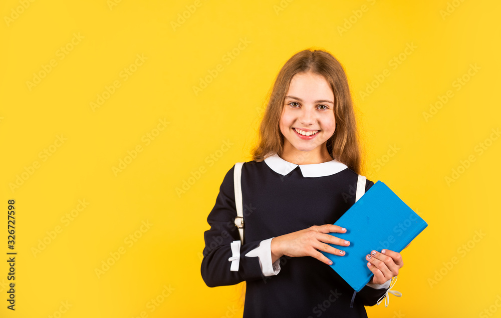 First day of school. Happy schoolgirl yellow background. Little schoolgirl back to school. Small schoolgirl wear school uniform. Charming look of cute schoolgirl. School and eduction, copy space First day of school. Happy schoolgirl yellow background. Little schoolgirl back to school. Small schoolgirl wear school uniform. Charming look of cute schoolgirl. School and eduction, copy space