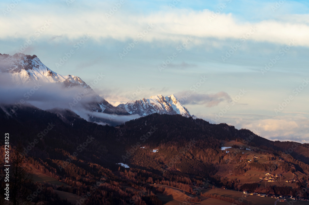 alps in winter at a cold day with low clouds and nice view alps in winter at a cold day with low clouds and nice view