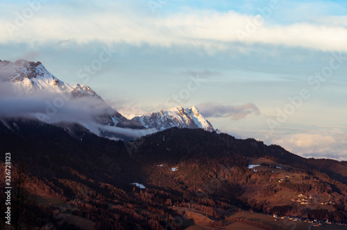 alps in winter at a  cold day with low clouds and nice view