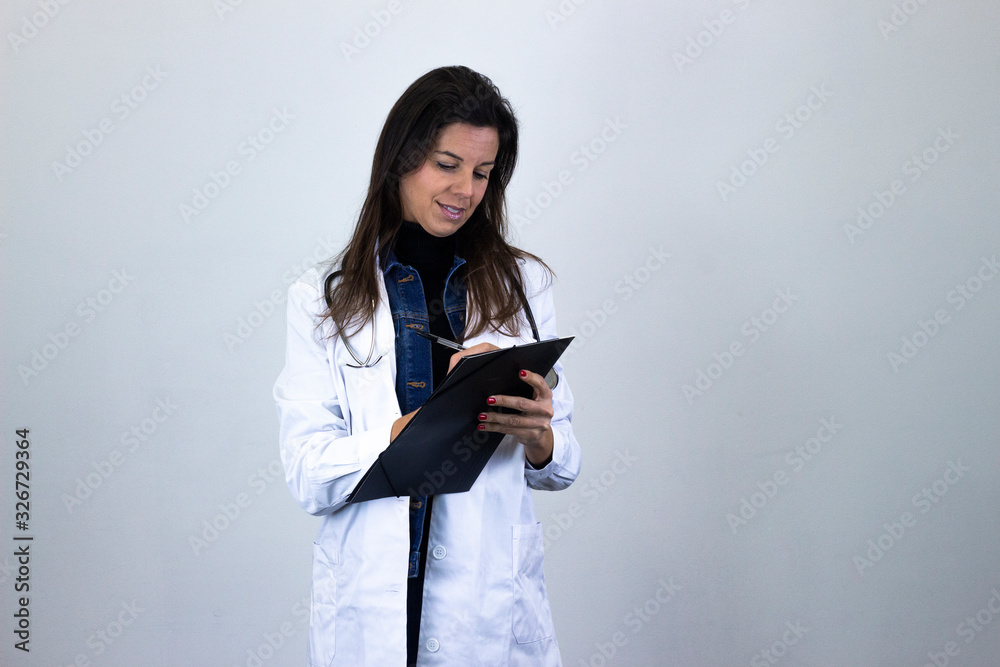 attractive caucasian middle age woman with a folder in her hands. Nurse, doctor, veterinarian, therapist, pharmacist, isolated on gray background studio shot, in white coat uniform, dark air. Place fo attractive caucasian middle age woman with a folder in her hands. Nurse, doctor, veterinarian, therapist, pharmacist, isolated on gray background studio shot, in white coat uniform, dark air. Place fo