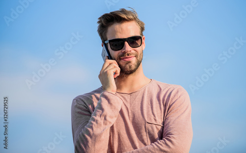 pleasant conversation. confident man speak on phone. Call to friend. macho man use mobile phone. modern technology in life. always in touch. sexy man sky background. guy casual style. Fashion model © be free