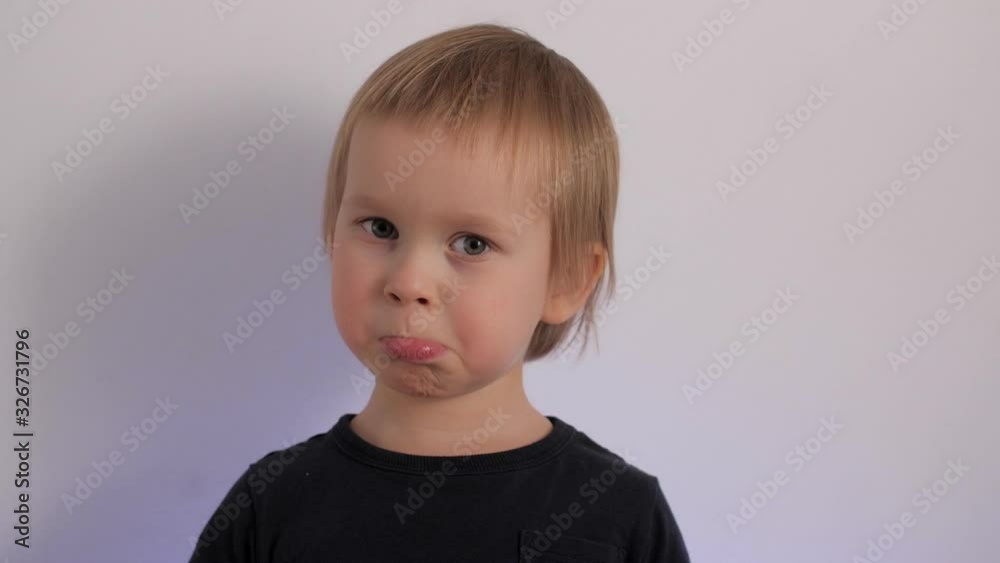 Portrait of focused upset cute little baby talking having negative emotion Portrait of focused upset cute little baby talking having negative emotion