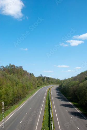 An English motorway seen without any traffic on a summer's day under a bright blue sky © Peter