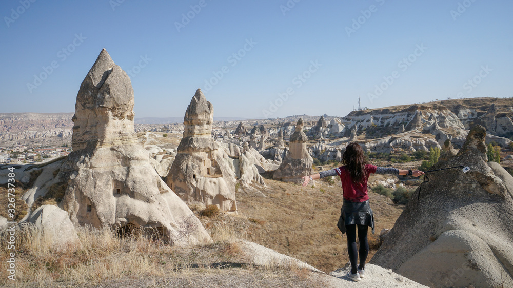 A brave woman travels through the incredible scenery and beautiful landscape of Cappadocia in Turkey.