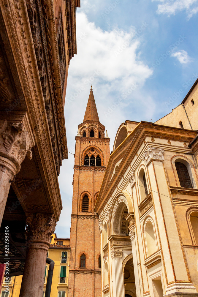 Mantova low-angle cityscape with the entrance of the Basilica of Sant'Andrea to the left and the bell tower in the background at Mantua, Lombardy, Italy