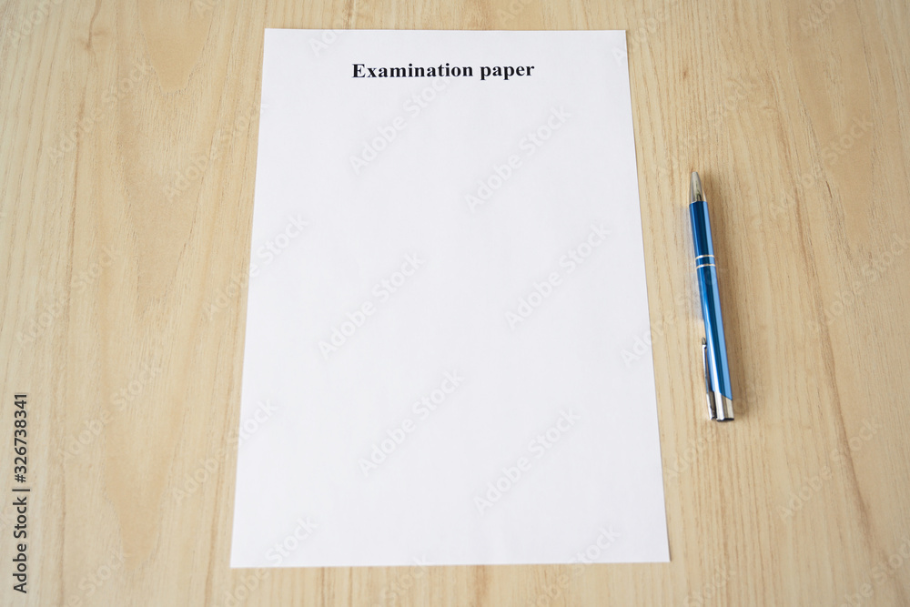 Empty examination paper for university with pen on the school desk. Copyspace. Mockup. Flat lay Empty examination paper for university with pen on the school desk. Copyspace. Mockup. Flat lay