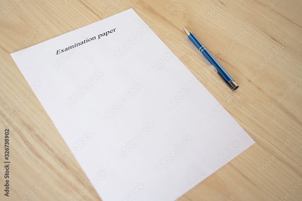 Empty examination paper for university with pen on the school desk. Copyspace. Mockup. Flat lay Empty examination paper for university with pen on the school desk. Copyspace. Mockup. Flat lay