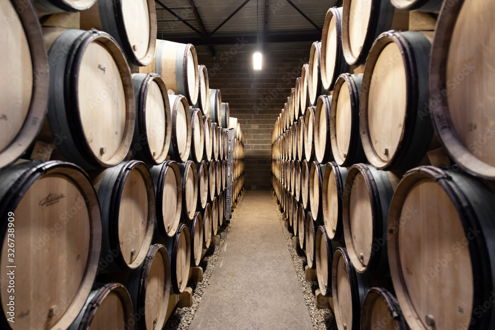 France Burgundy 2019-06-20 Wooden wine oak barrels stacked in winery cellar France Burgundy 2019-06-20 Wooden wine oak barrels stacked in winery cellar