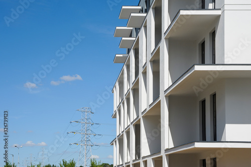 Modern building under construction. White walls and blue sky