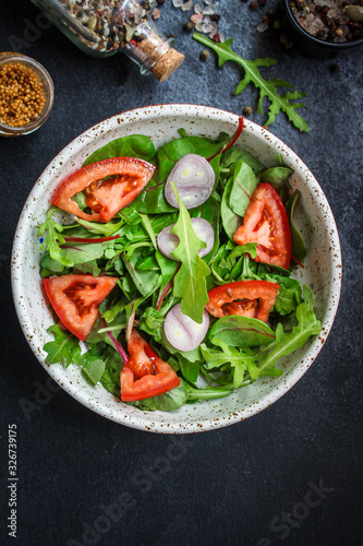 healthy salad tomato, mix leaves, onions and other ingredients, vegan, keto or paleo menu concept. top food background. copy space