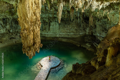 Man enjoying the view of Suytun Cenote from the top Yucatan Mexico North America
