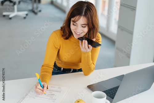 Carta da parati Young woman talking into her mobile phone