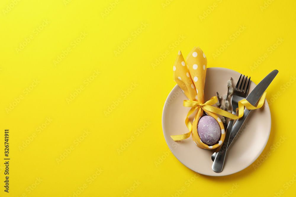 Easter table setting on yellow background, space for text